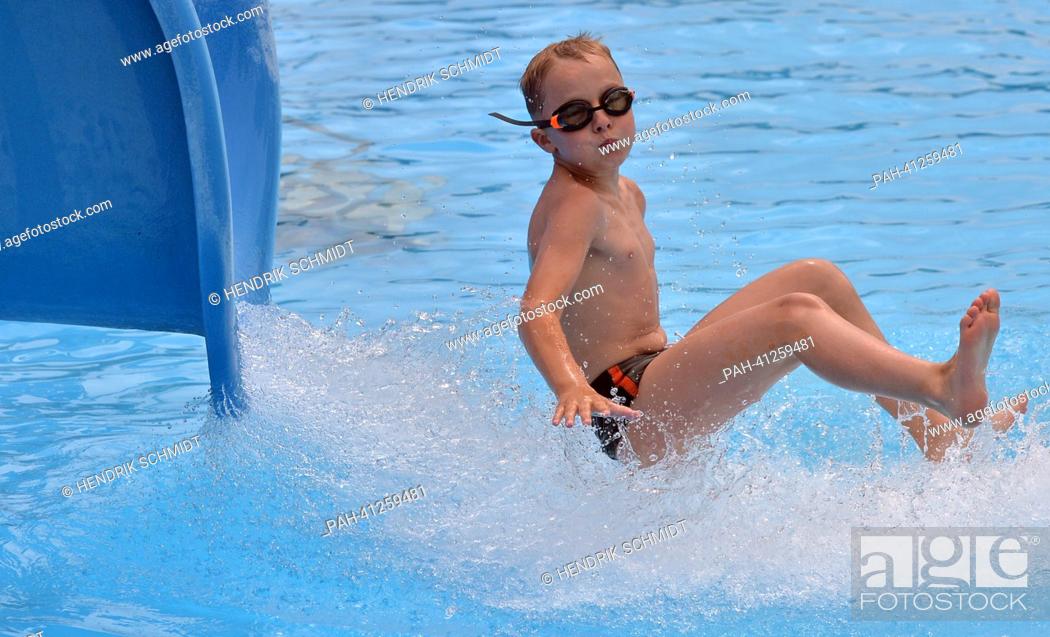Stock Photo: A boy slides into the water in the bath of Rebesgruen, Germany, 24 July 2013. This weekend the 17th German water sliding championship will take place in the.
