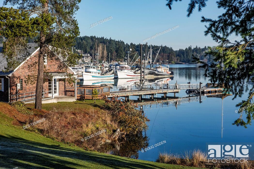 Stock Photo: A serene morning view looking across a portion of the the marina and fishing boats at Gig Harbor; Gig Harbor, Washington, United States of America.
