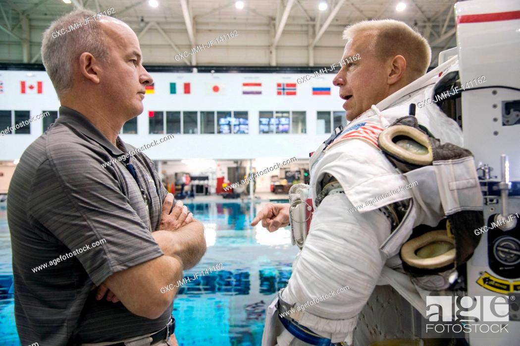 Stock Photo: NASA astronaut Tim Kopra (right), Expedition 46 flight engineer and Expedition 47 commander, attired in a training version of his Extravehicular Mobility Unit.