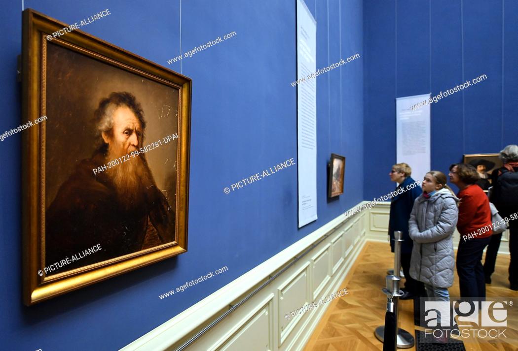 Stock Photo: 20 January 2020, Thuringia, Gotha: Visitors look at the painting ""Old Man"" by Jan Lievens (1607-1674). After their theft about 40 years ago.