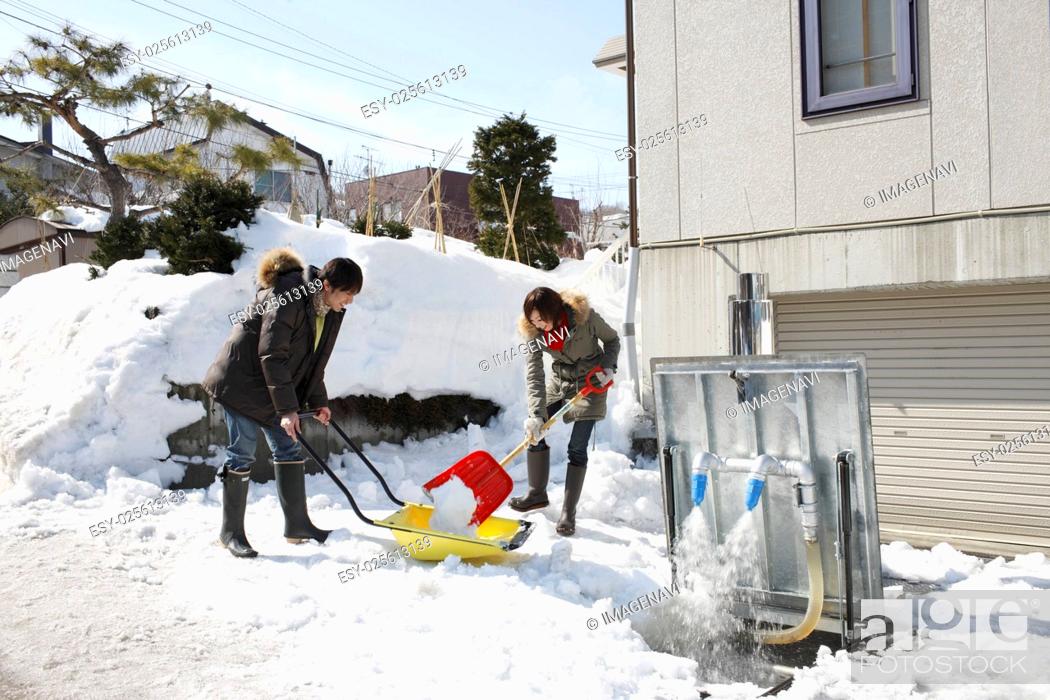 Stock Photo: Couple removing snow.