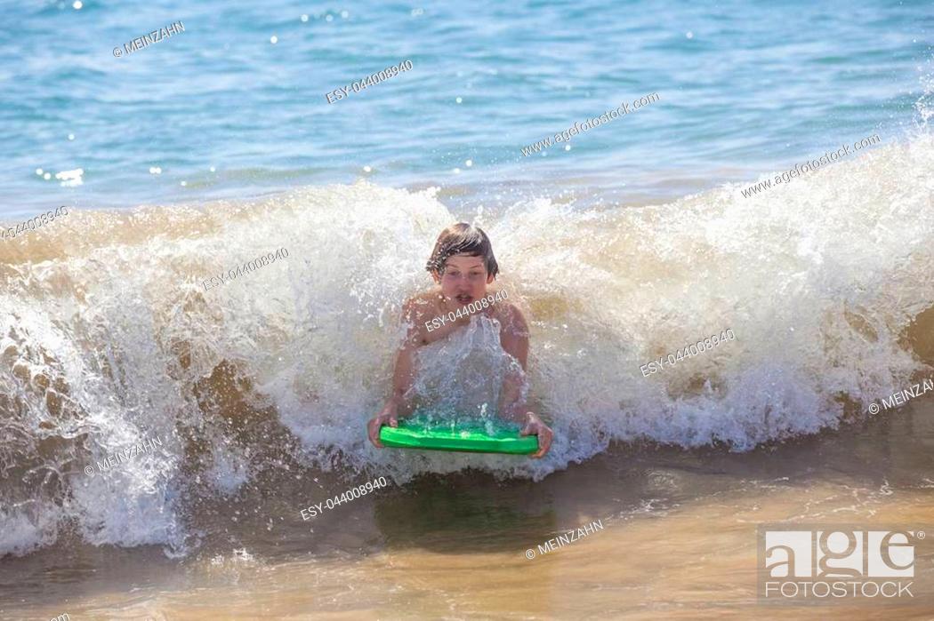 Stock Photo: boy has fun surfing in the waves in Lanzarote.