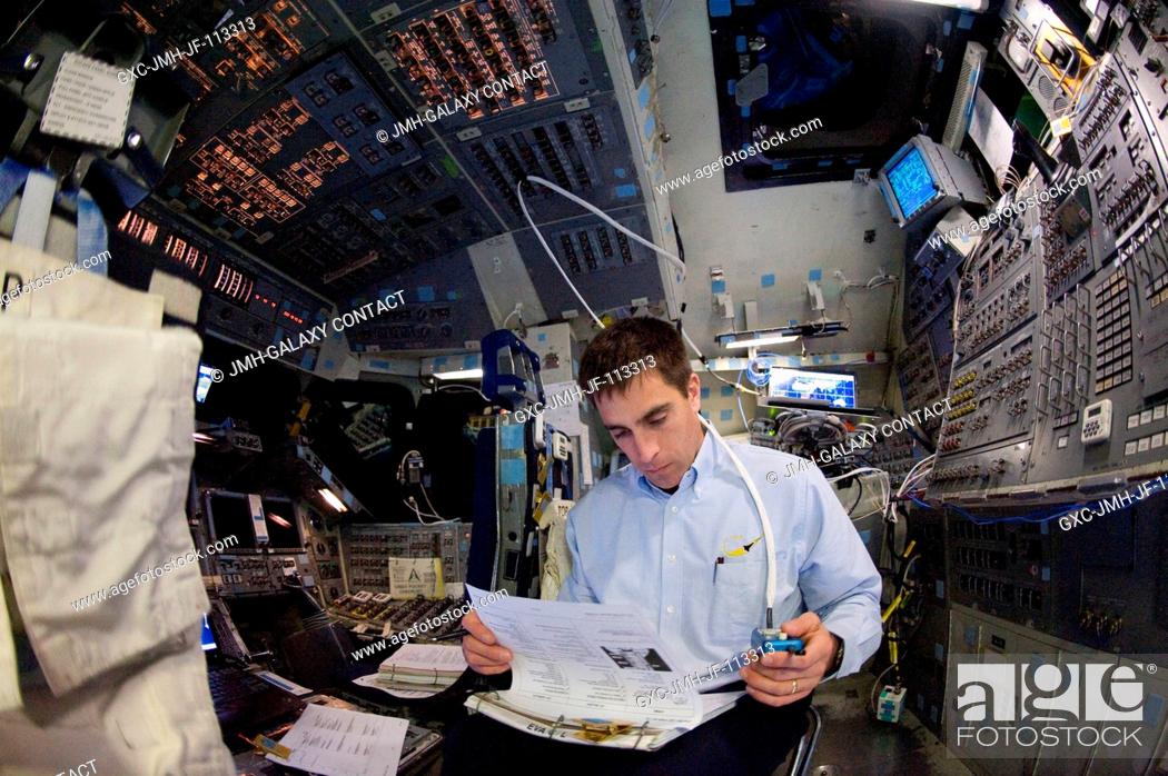 Stock Photo: Astronaut Christopher Cassidy, STS-127 mission specialist, looks over a checklist during a training session in the Jake Garn Simulation and Training Facility at.