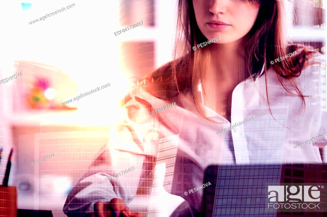 Imagen: Portrait of attractive european woman working on abstract city background with sunlight. Double exposure.