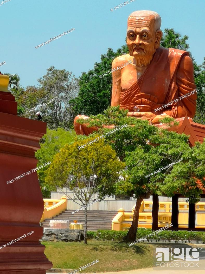 Stock Photo: 04 March 2019, Thailand, Ao Luek Distrikt: The oversized statue of a Buddhist monk on the estate at Wat Maha That Wachira Mongkol or Wat Bang Tong.