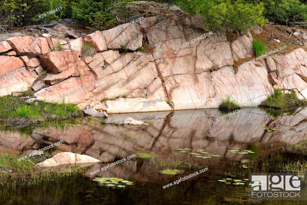 Stock Photo: Canadian Shield granite outcrops reflected in a beaver pond, Killarney, Ontario, Canada.