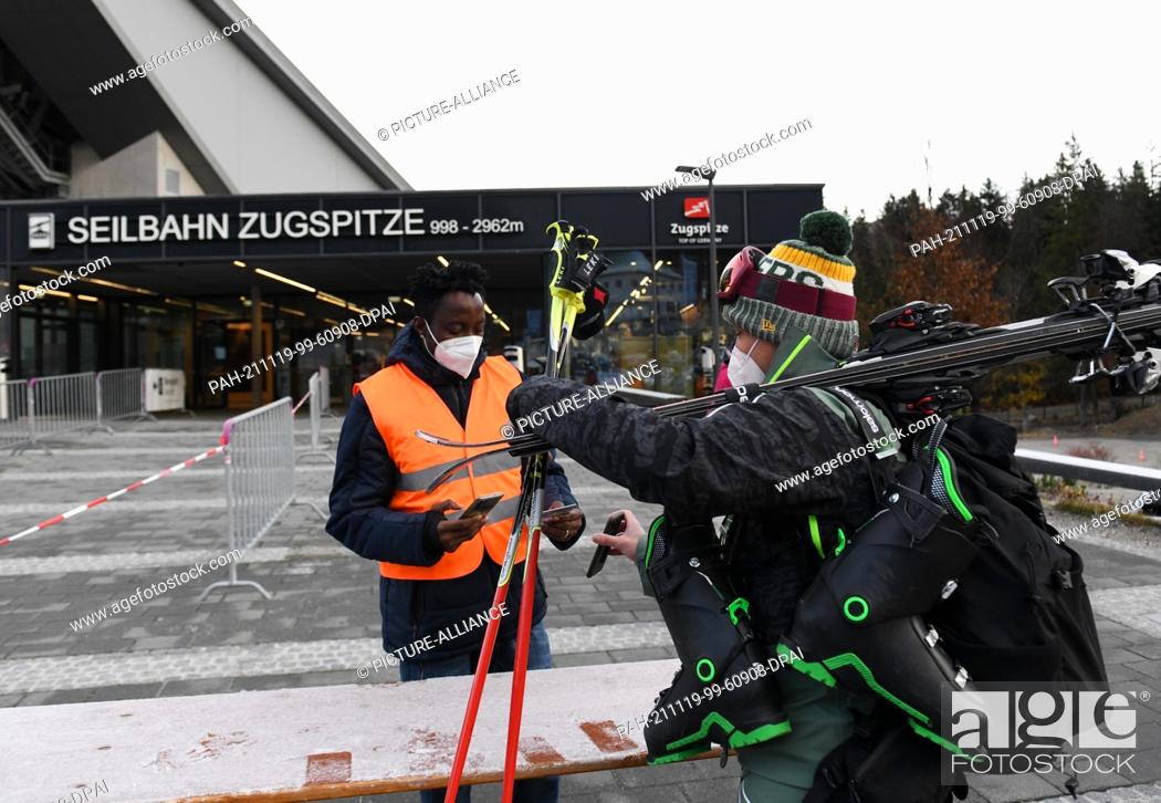 Stock Photo: 19 November 2021, Grainau: Skiers arrive at the 2G control at the Talstadion. Germany's highest ski resort on the Zugspitze started the winter season 2021/2022.