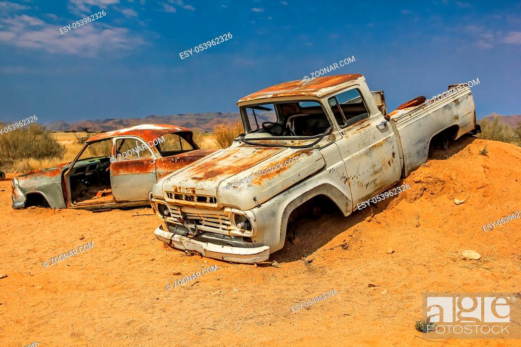 Stock Photo: Namibia desert area, Namibia, Africa, Cars wreck in the desert near a solitaire small ghost town in the dunes.