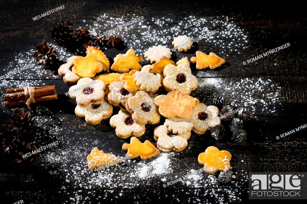 Stock Photo: Different Christmas cookies and spices on black wood.
