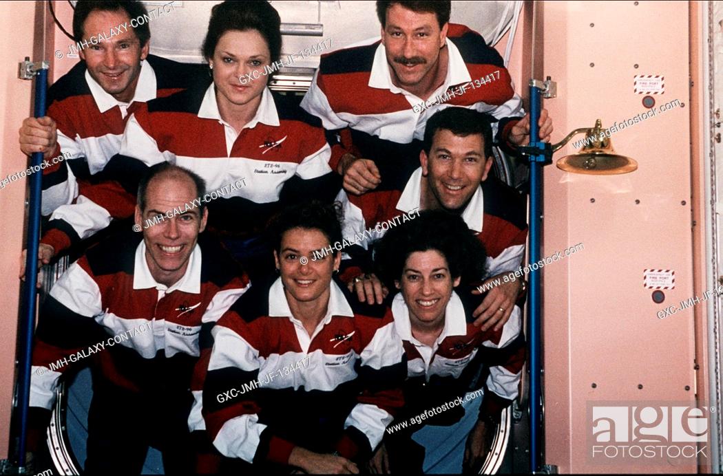Stock Photo: The seven crew members for the STS-96 mission pose for the traditional inflight crew portrait in the hatch way of the U.S.