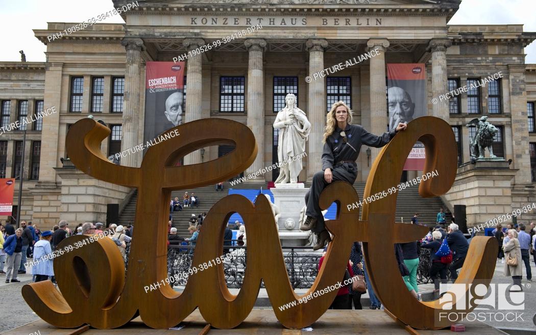 Stock Photo: 26 May 2019, Berlin: The artist Mia Florentine Weiss sits at the Gendarmenmarkt on her sculpture ""LOVE HATE"". There, supporters of the European initiative.