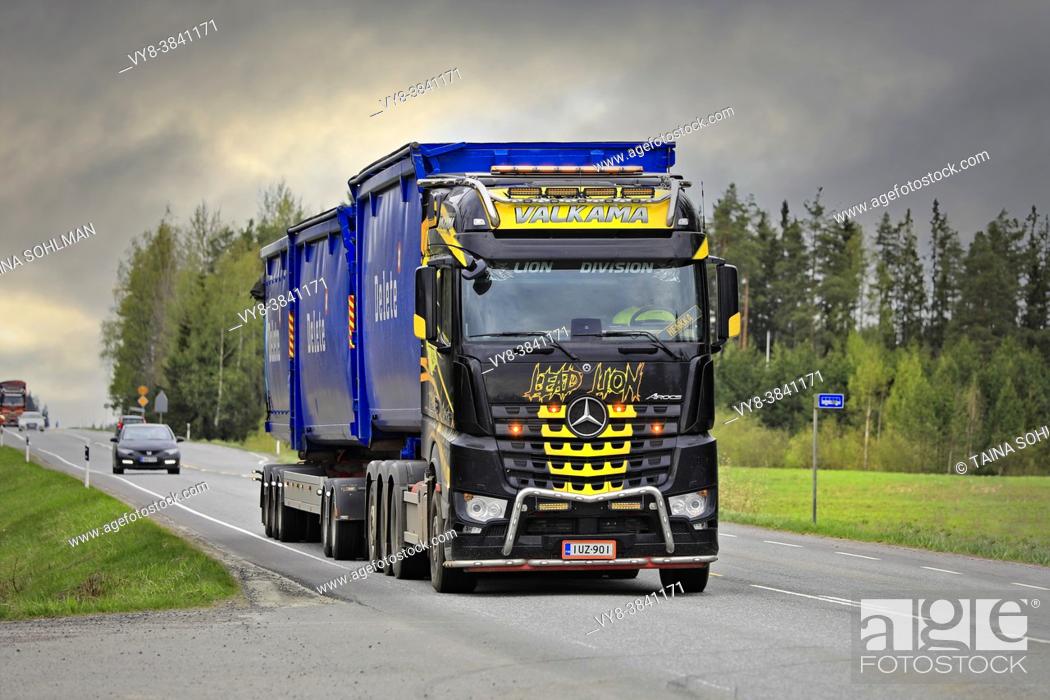 Stock Photo: Beautifully customised Mercedes-Benz Arocs hooklift truck Lead Lion of Maanrakennus Valkama Oy pulls Delete trailers. Jokioinen, Finland. May 14, 2021.