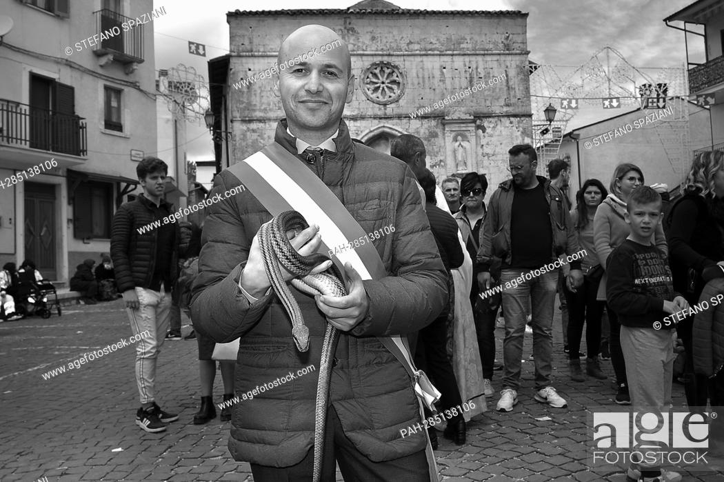 Stock Photo: After two years of interruption due to the pandemic, the procession of snakes in Cocullo takes place on 1 May 2022.The Mayor of Cocullo with snakes in hand.