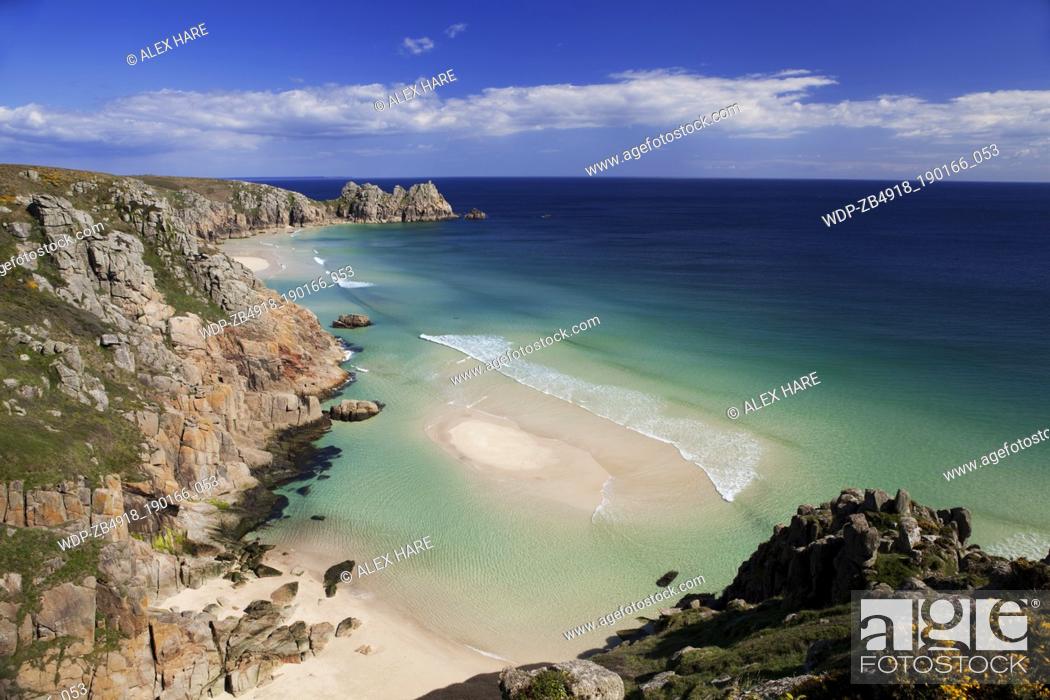 Photo de stock: A view of the sandy beach at Porthcurno with Logan rock in the distance.