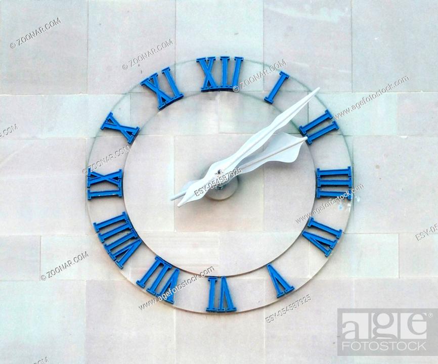 Stock Photo: old clock on commercial building wall with roman numerals.