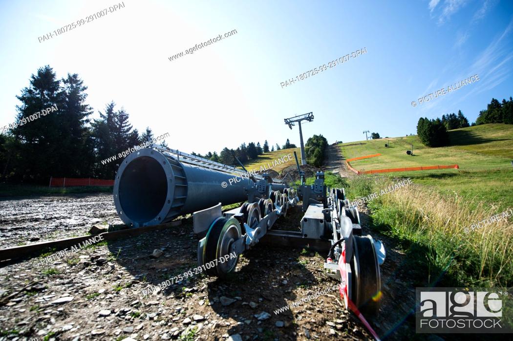 Stock Photo: 25 July 2018, Willingen, Germany: Parts of a chairlift support of the new 8-seater chairlift ""K1 Willingen"" on the Köhlerhagen slope lie on the slope.
