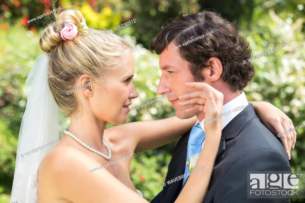 Stock Photo: Groom looking at his pretty blonde wife.