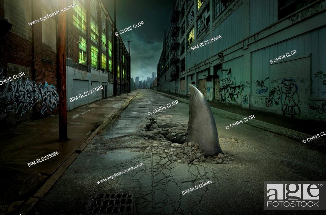 Stock Photo: Shark fin swimming in dilapidated city street.