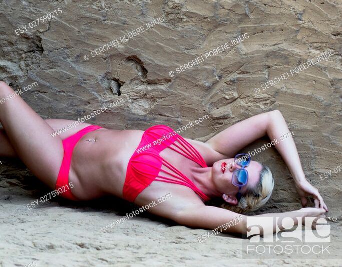 Stock Photo: body of the sunbathing woman at the clay rock, a subject beautiful women.