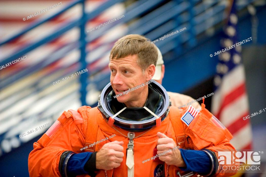Stock Photo: NASA astronaut Chris Ferguson, STS-135 commander, dons a training version of his shuttle launch and entry suit in preparation for an emergency egress training.