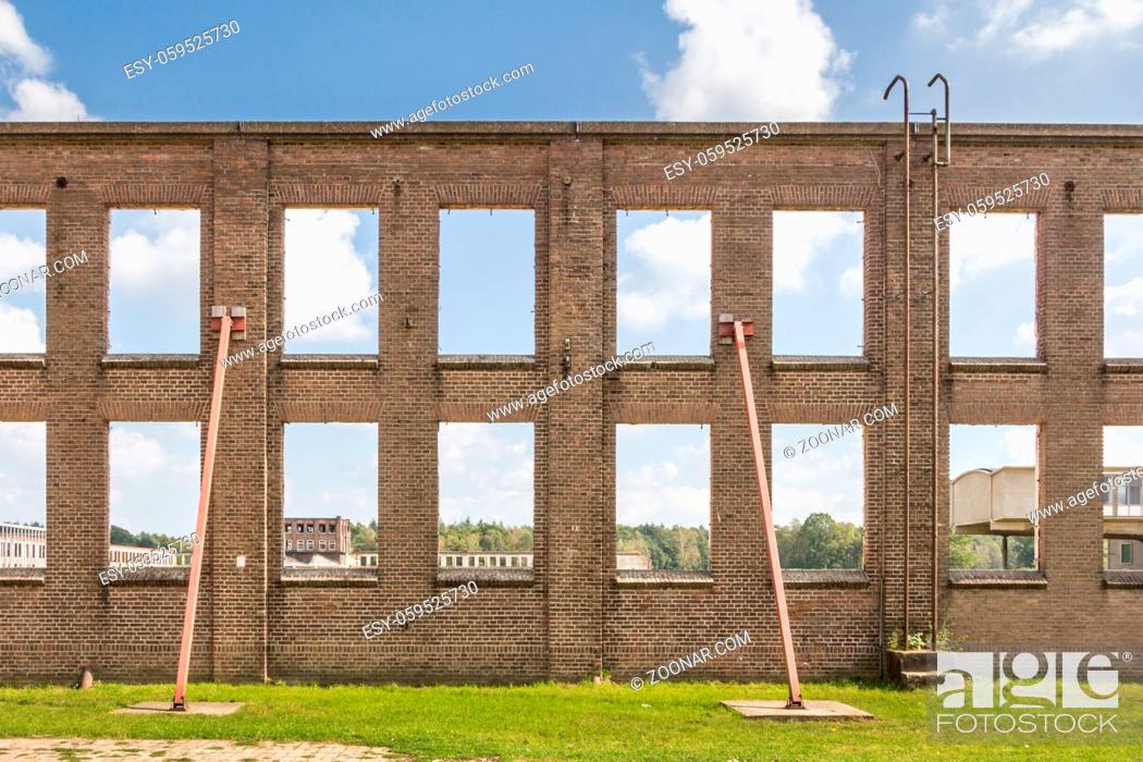 Stock Photo: Winows with no glass of an abandoned industrial building in Ede in the Netherlands.