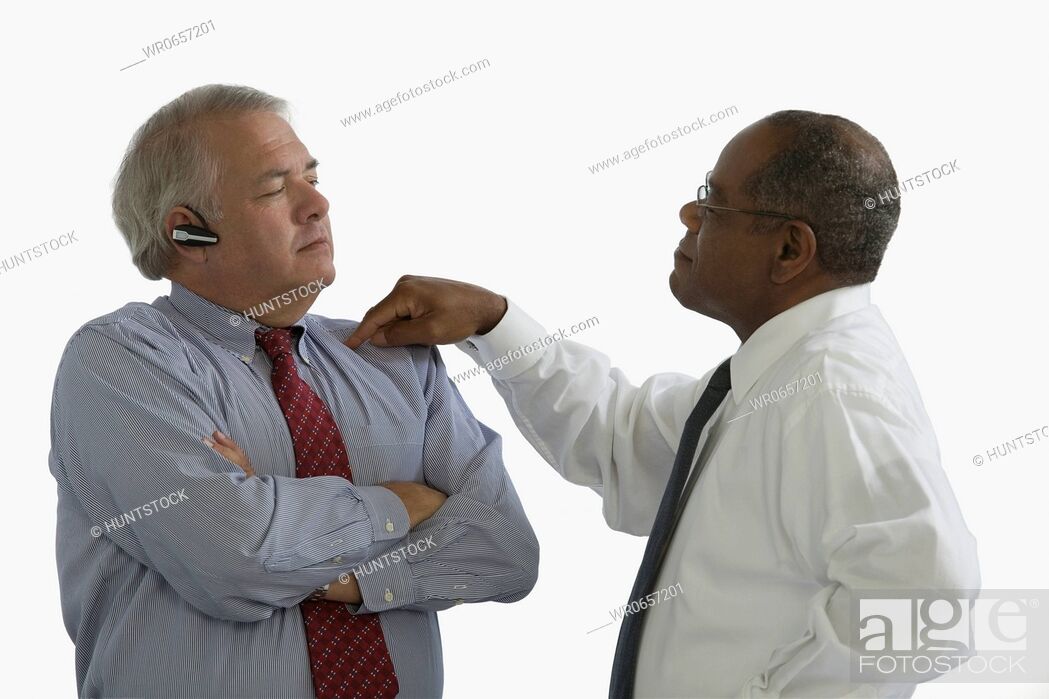 Stock Photo: Side profile of a businessman blaming another businessman.