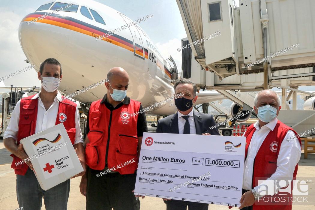 Stock Photo: 12 August 2020, Lebanon, Beirut: German Foreign Minister Heiko Maas (2nd R) hands George Kettaneh (R), an official of the Lebanese Red Cross.