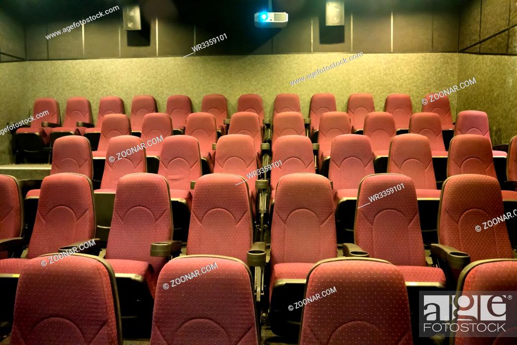 Imagen: Empty seats in the small movie theater with cinema projector.