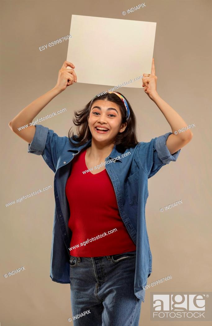 Stock Photo: Portrait of a young woman holding white sheet with her both hands.