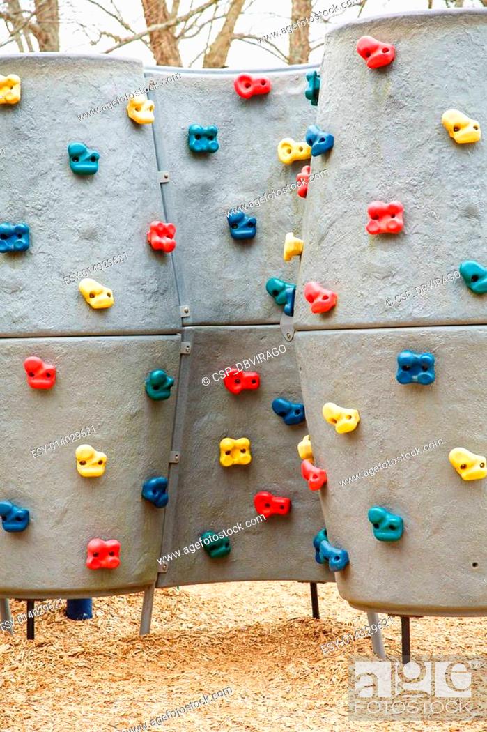 Stock Photo: Kids Climbing Wall with Colorful Handholds.
