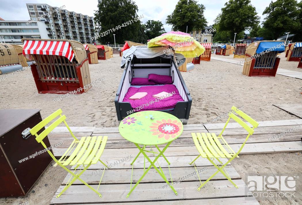 Stock Photo: 07 July 2022, Schleswig-Holstein, Travemünde: A sleeping beach chair of the beach chair rental Seipel is prepared for the next guests during a photo session.