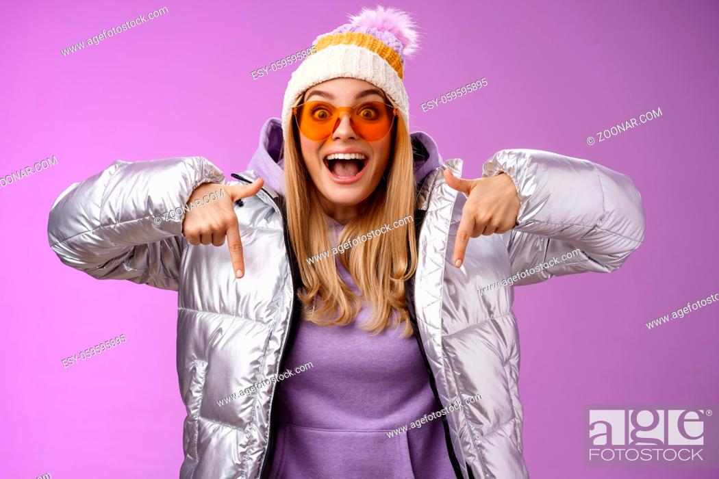 Stock Photo: Lifestyle. Excited impressed good-looking blond girl drop jaw amused overwhelmed pointing down index fingers checking out awesome promotion standing surprised.