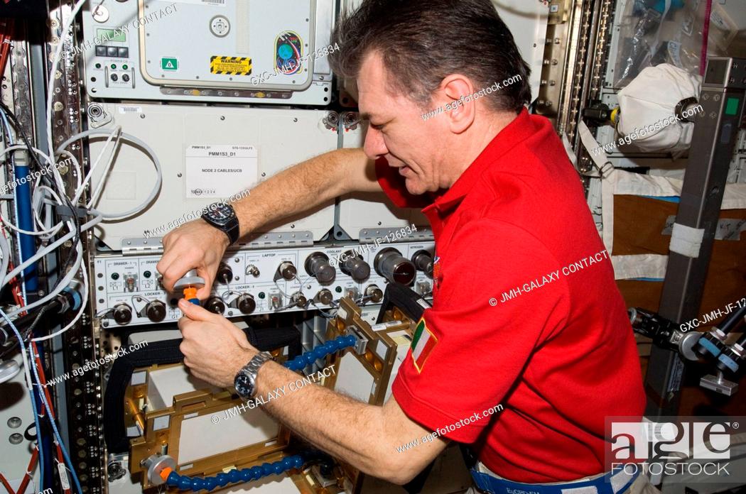 Stock Photo: European Space Agency astronaut Paolo Nespoli, Expedition 27 flight engineer, works with Anomalous Long Term Effects on Astronauts (ALTEA) Shield isotropic.