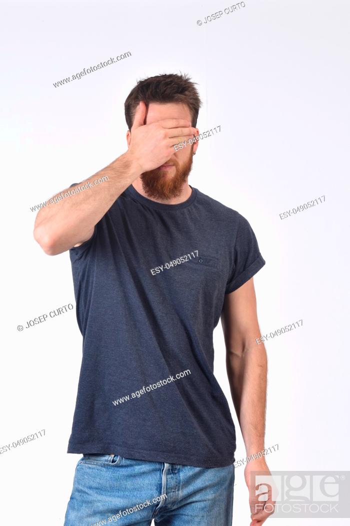 Stock Photo: man cover his eyes with his hand.