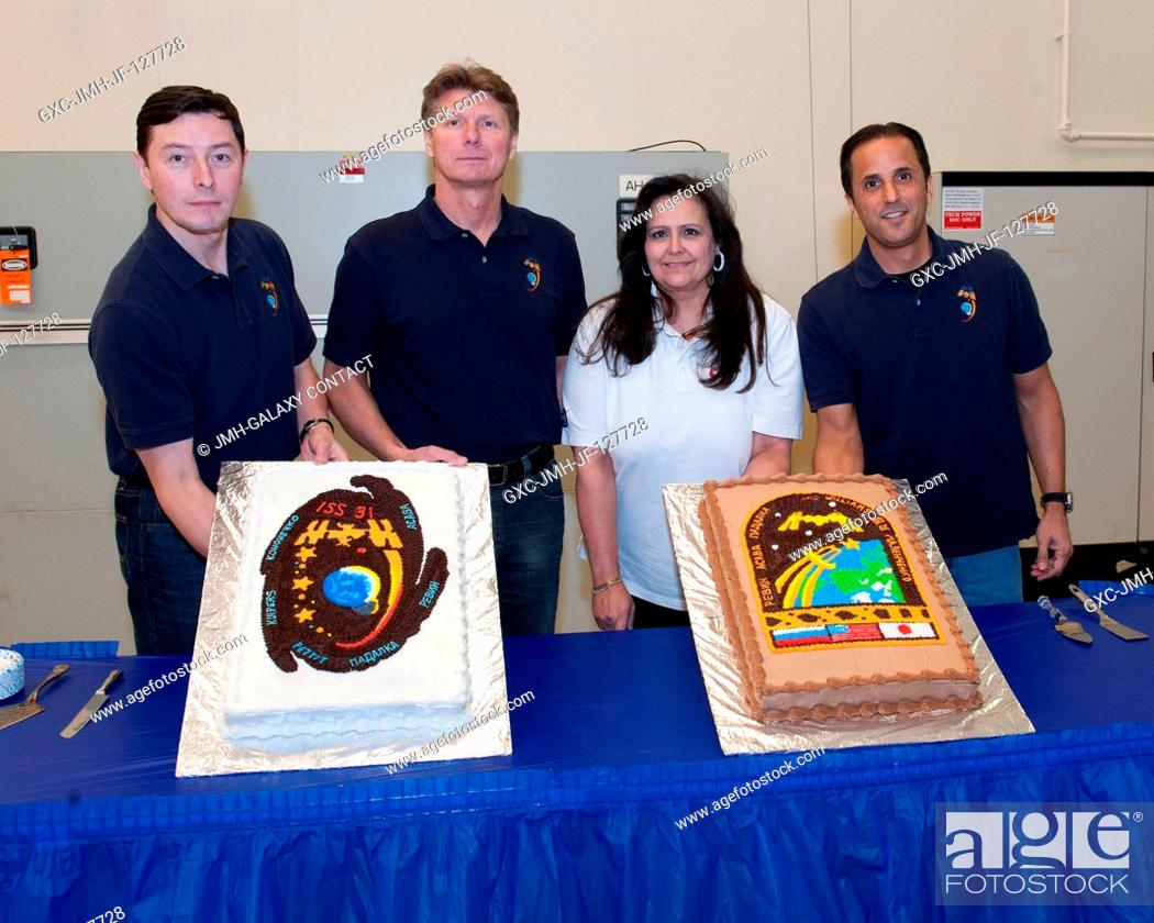 Stock Photo: Expedition 3132 crew members, along with Bonnie Land, pose for a photo during a cake-cutting ceremony in the Jake Garn Simulation and Training Facility at.