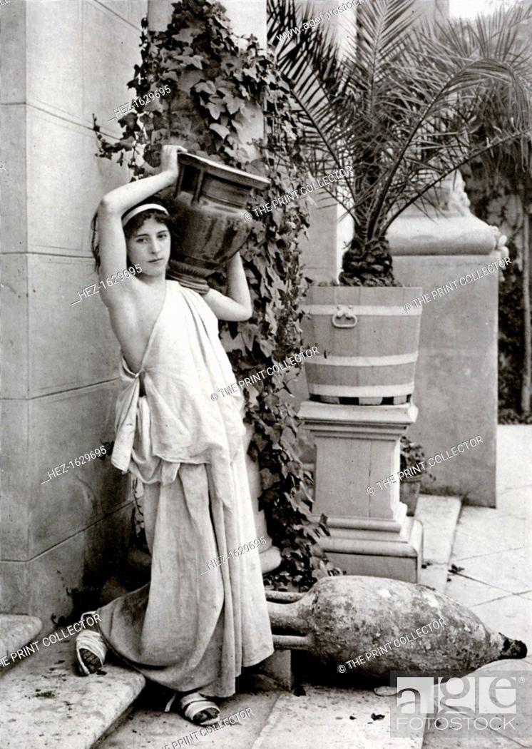 Stock Photo: A young woman carrying a Roman vase on her shoulder, 1902-1903. From Penrose's Pictorial Annual 1902-1903, An Illustrated Review of the Graphic Arts, volume 8.