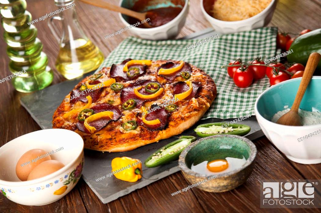 Stock Photo: Delicious pizza served on wooden table.