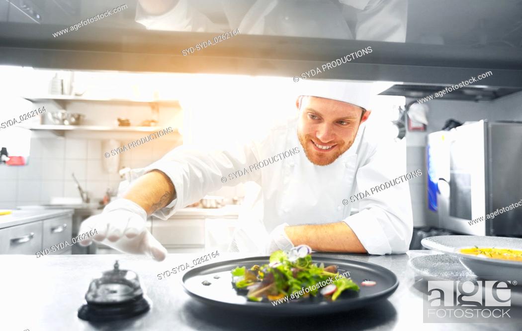 Stock Photo: happy male chef cooking food at restaurant kitchen.