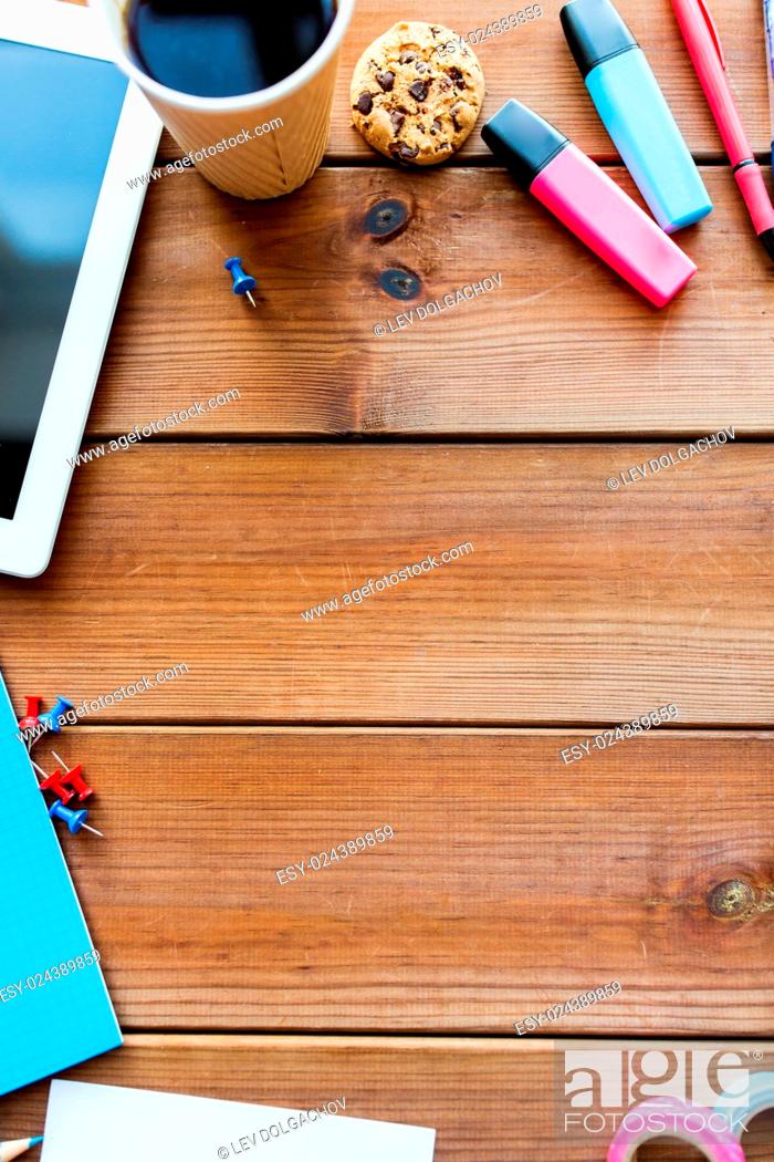 Stock Photo: education, school supplies, art, creativity and object concept - close up of stationery and tablet pc computer with coffee cup on wooden table.