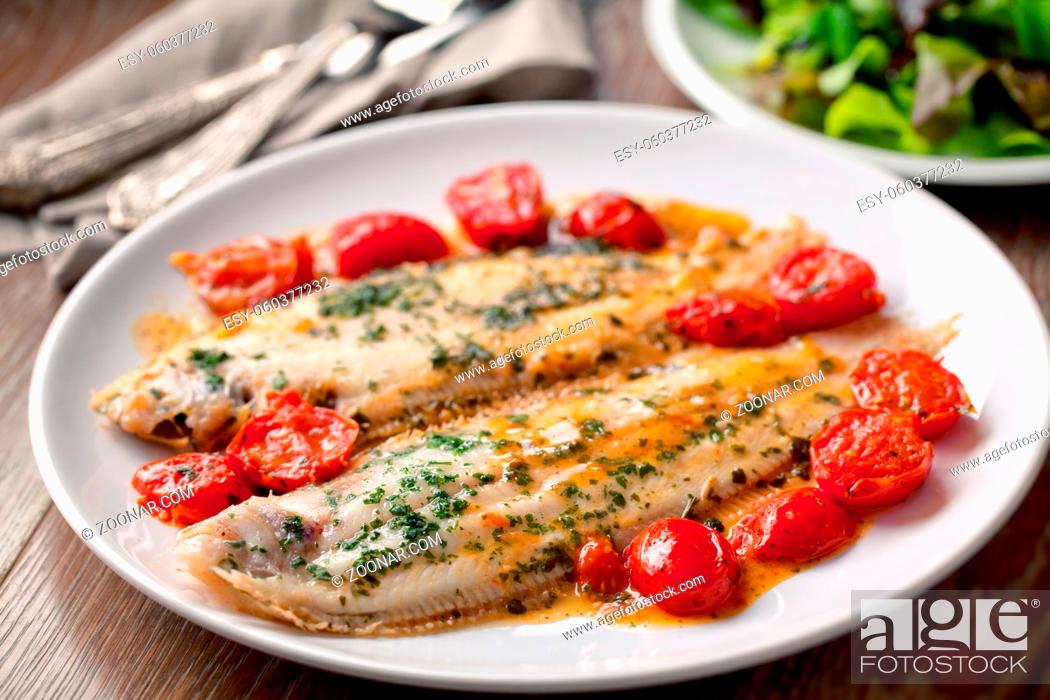 Stock Photo: Sole with cherry tomatoes on a plate. High quality photo.
