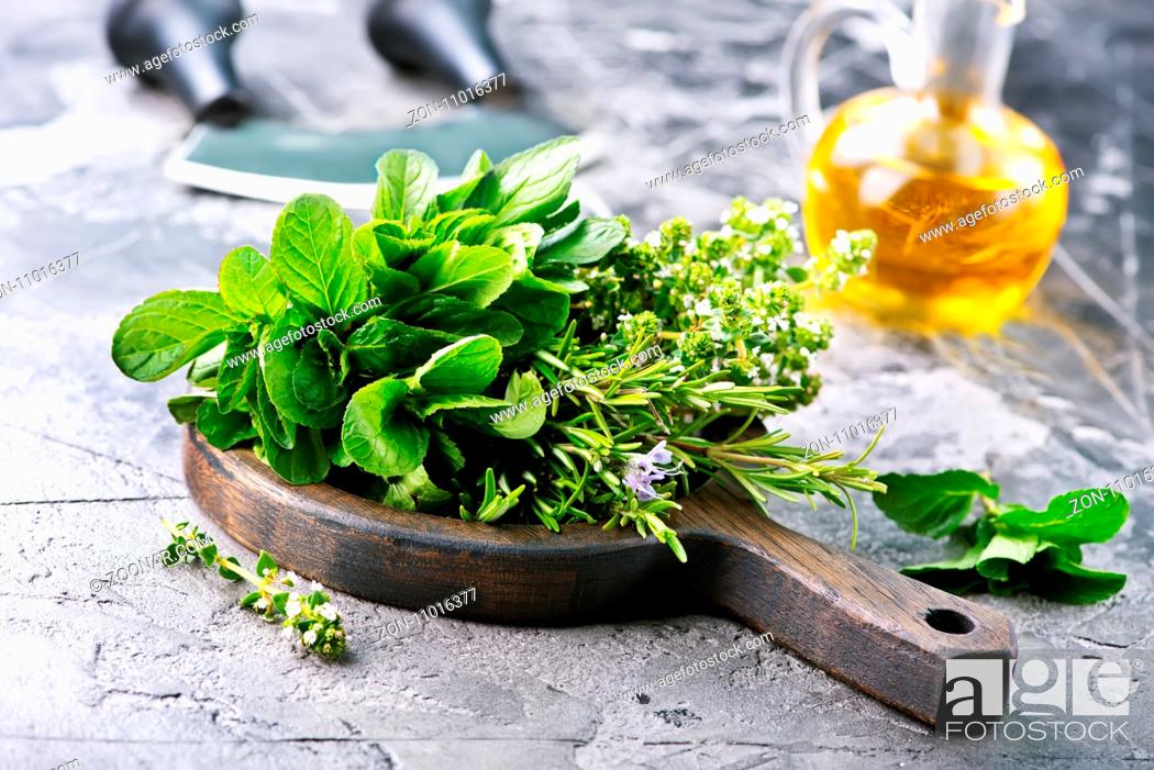 Stock Photo: fresh herb on board and on a table.