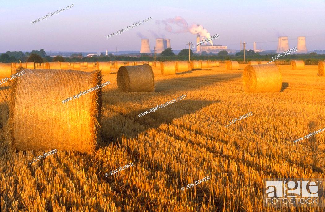 Stock Photo: England, Oxfordshire, Didcot, Didcot Power Station and cornfield that has just been harvested.