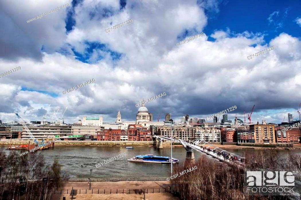 Stock Photo: LONDON - May 4: urban landscape with St. Paul's Cathedral and Millennium Bridge, officially known as the London Millennium Footbridge, on March 23.