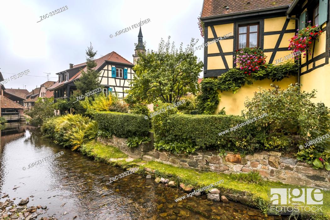 Stock Photo: old village Andlau, Alsace Wine Route, France, half-timbered houses and flower decoration at the brook side.
