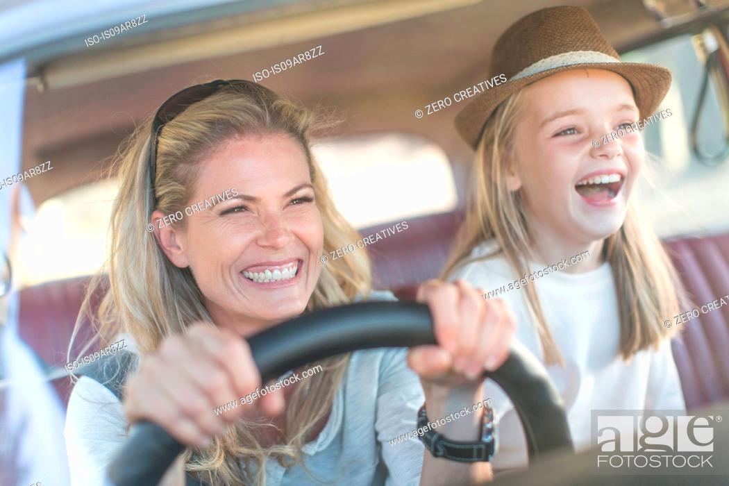Stock Photo: Mother and daughter in car together, smiling.