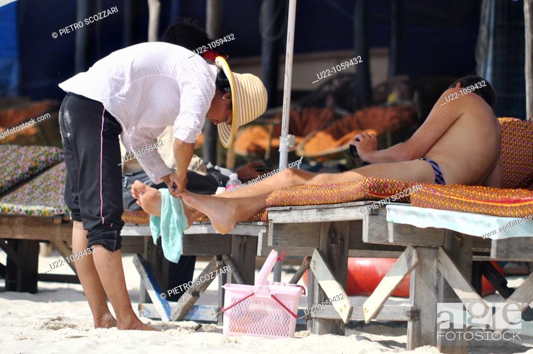 Stock Photo: Sihanoukville (Cambodia): pedicure for tourists at Occheuteal Beach.