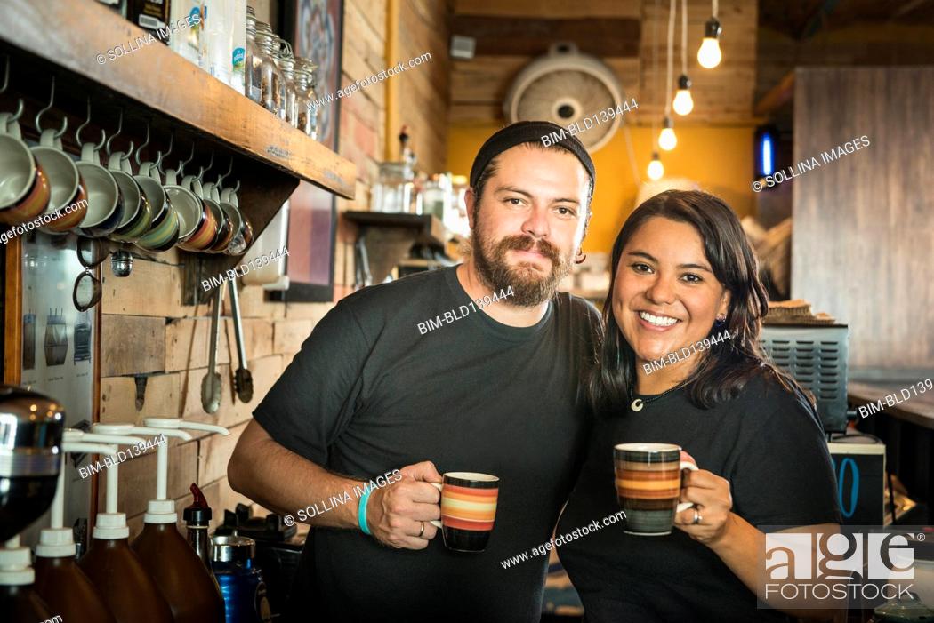 Stock Photo: Hispanic couple working in coffee shop.