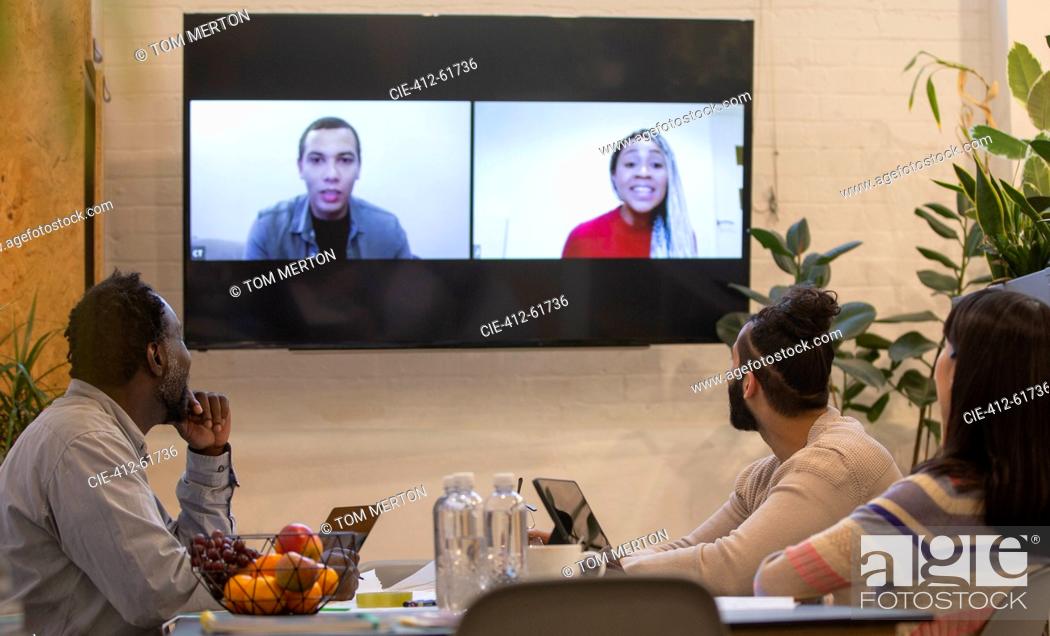 Stock Photo: Business people video conferencing in office meeting.