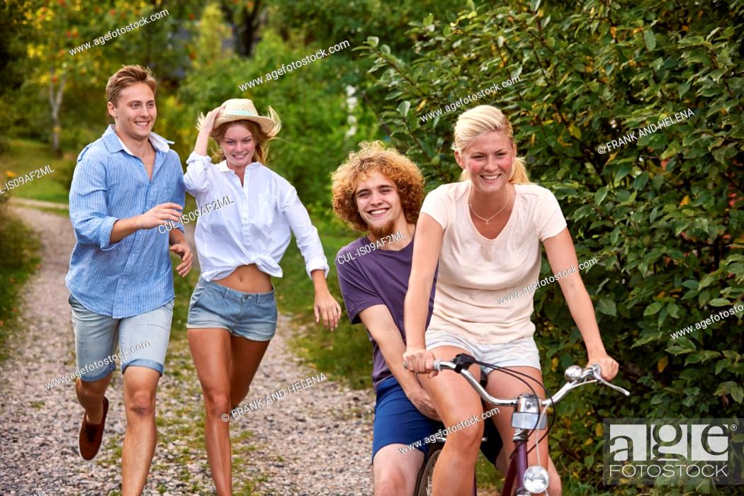 Stock Photo: Two young couples chasing each other on bicycle, Gavle, Sweden.