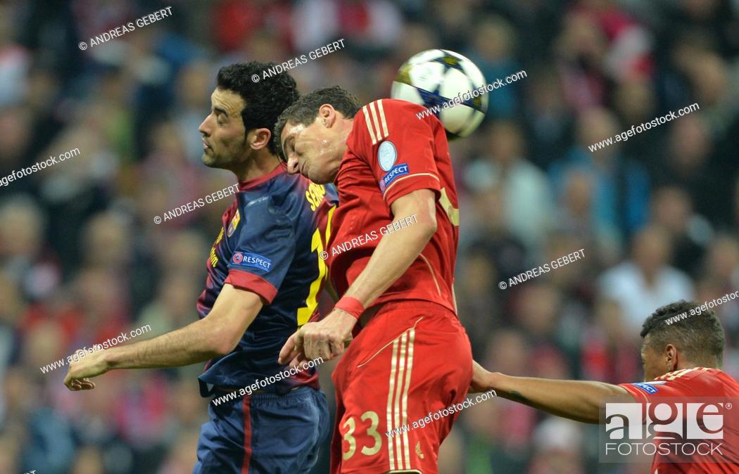Stock Photo: Munich's Mario Gomez (R) and Barcelona's Sergio Busquets fight for the ball during the UEFA Champions League semi final first leg soccer match between FC Bayern.